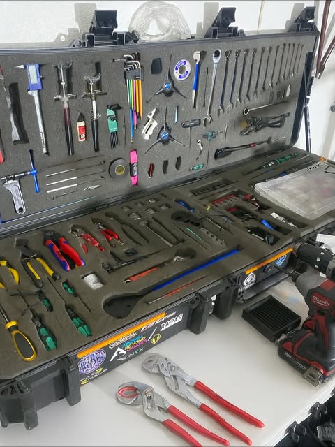 The Bike Studio's mobile tool case — bicycle service tools laid out in cut foam trays.